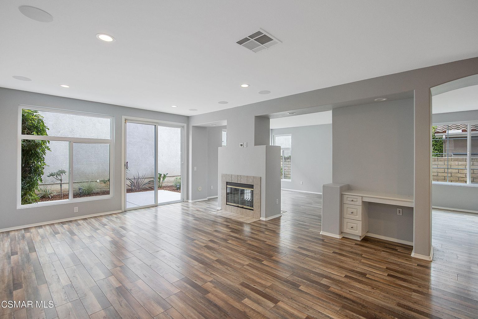 Dining alcove next to fireplace with garden view.