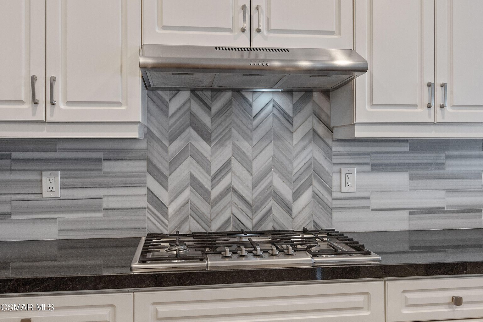 Primary bedroom with carpet, oversized window, and ample wall space.