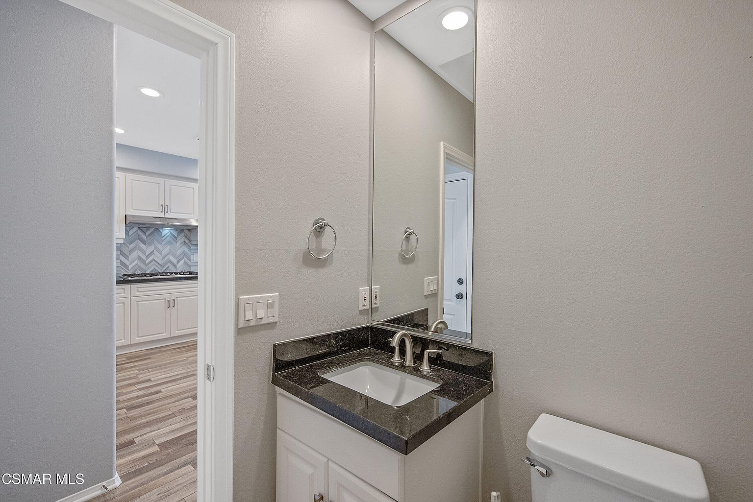 Primary bath with double vanity, soaking tub, and natural light.